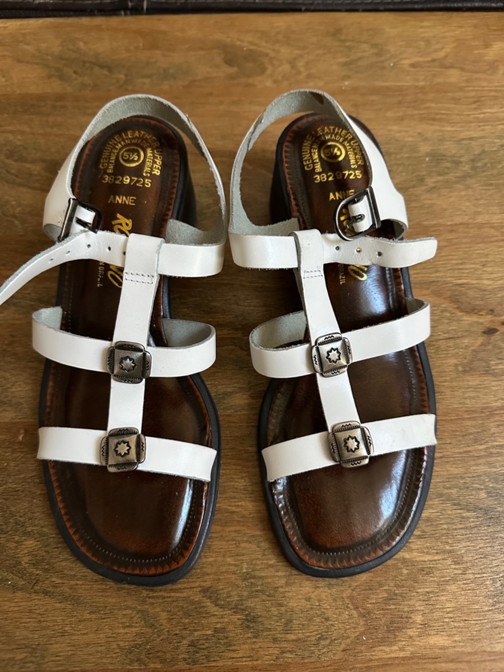 Romano Anne White Multi-Strap Leather Sandals with Buckle Accents.